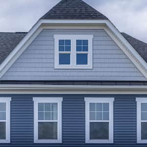 Shingles on a gabled roof of a brick house