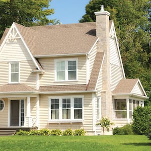 Cottage home with a peaked, shingle roof