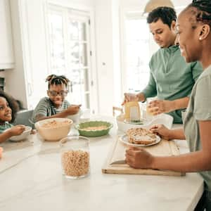 Family eating breakfast at kitchen island