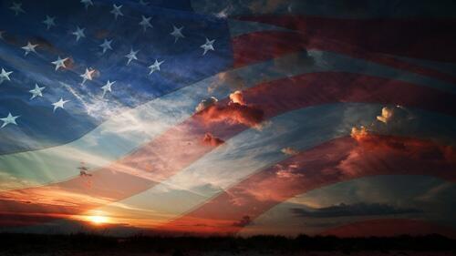 American flag silhouetted against the sky