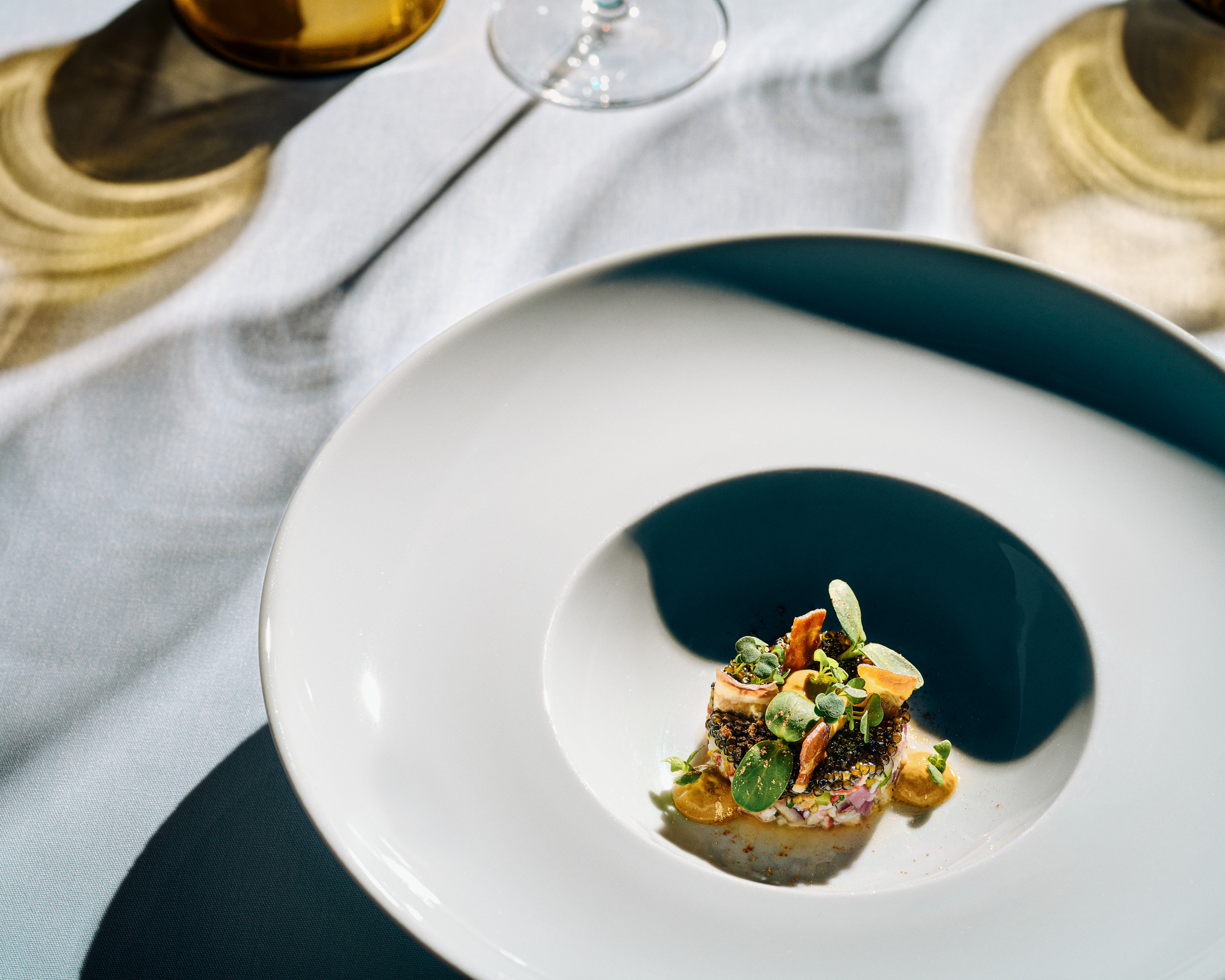 Food in round plate on white table cloth