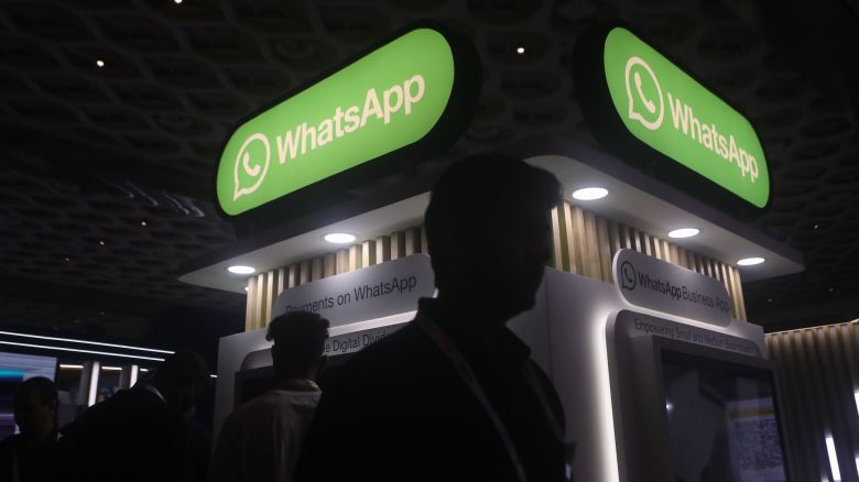 People walk past logos of the WhatsApp application during Global Fintech Fest in Mumbai, India, 20 September, 2022. (Photo by Niharika Kulkarni/NurPhoto via Getty Images)