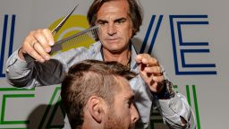 Julien Farel cuts the hair of US Open player Austin Krajicek at Farel's salon in Arthur Ashe stadium in Queens, New York, on Wednesday, August 30.