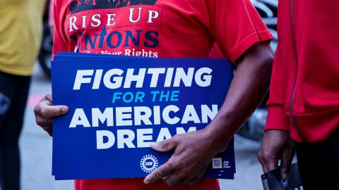 A United Auto Workers union member holds a sign outside Stellantis Sterling Heights Assembly Plant, to mark the beginning of contract negotiations in Sterling Heights, Michigan, U.S.  July 12, 2023.  