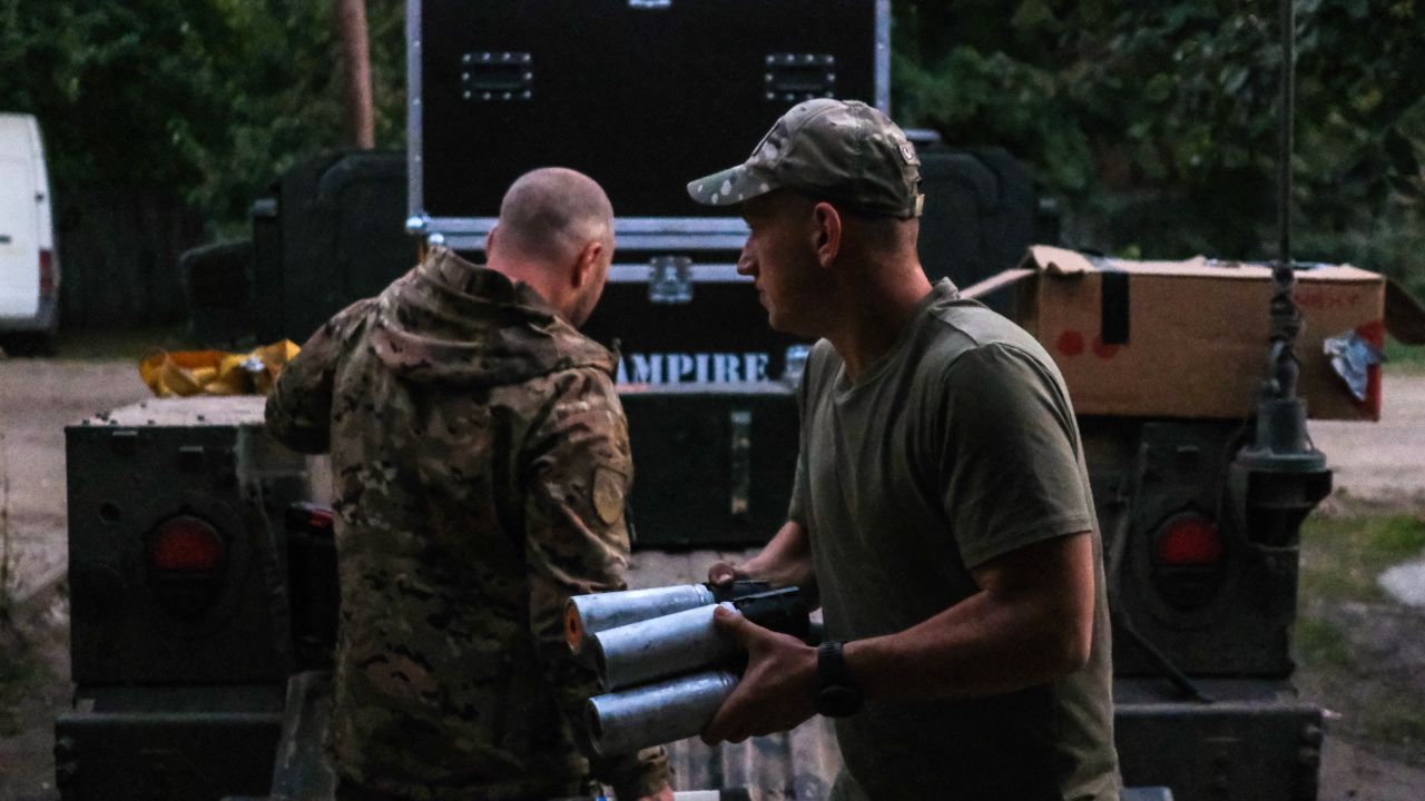 Ukrainian soldiers load drones and ammunition into the back of a US-donated Humvee before a night-time assault.