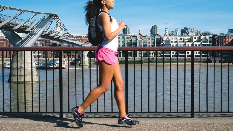 Beautiful woman running in city street.