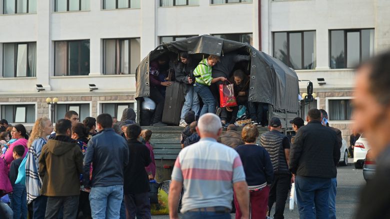 Residents of Stepanakert board a vehicle, as thousands of ethnic Armenians begin to flee Nagorno-Karabakh, September 25, 2023.