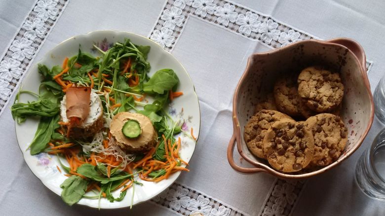 Appetizers and chocolate cookies with water - stock photo