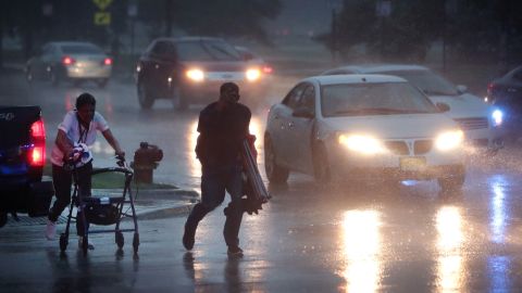 CHICAGO, ILLINOIS - AUGUST 10: People search for cover as a derecho storm pushes through the area on August 10, 2020 in Chicago, Illinois. The storm, with winds gusts close to 100 miles per hour, downed trees and power lines as it moved through the city and suburbs. (Photo by Scott Olson/Getty Images)