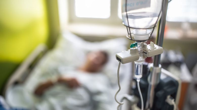 Drip infusion of a patient in a hospital room.