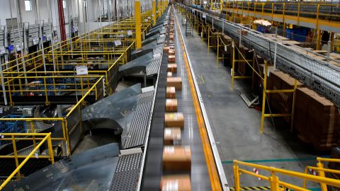 A fast-moving conveyor moves packages to delivery trucks during operations on Cyber Monday at Amazon's fulfillment center in Robbinsville, New Jersey, U.S., November 29, 2021. 