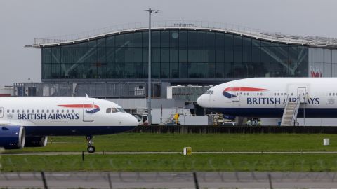 Passenger airplanes, operated by British Airways, next to terminal 5 at London Heathrow Airport in London, UK, on Friday, March 31, 2023. British Airways is set to scrap 320 flights during the Easter week as security workers strike for 10-days over pay. Photographer: Chris Ratcliffe/Bloomberg