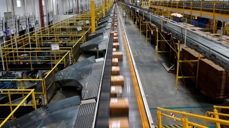 A fast-moving conveyor moves packages to delivery trucks during operations on Cyber Monday at Amazon's fulfillment center in Robbinsville, New Jersey, U.S., November 29, 2021.