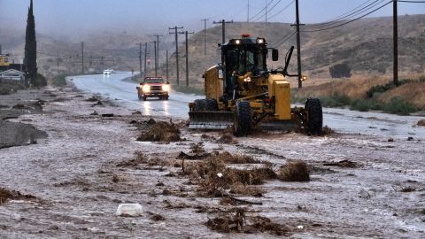 A plow clears debris along a flooded Sierra Highway in Palmdale, Calif., as Tropical Storm Hilary moves through the area on Sunday, Aug. 20, 2023. (AP Photo/Richard Vogel)