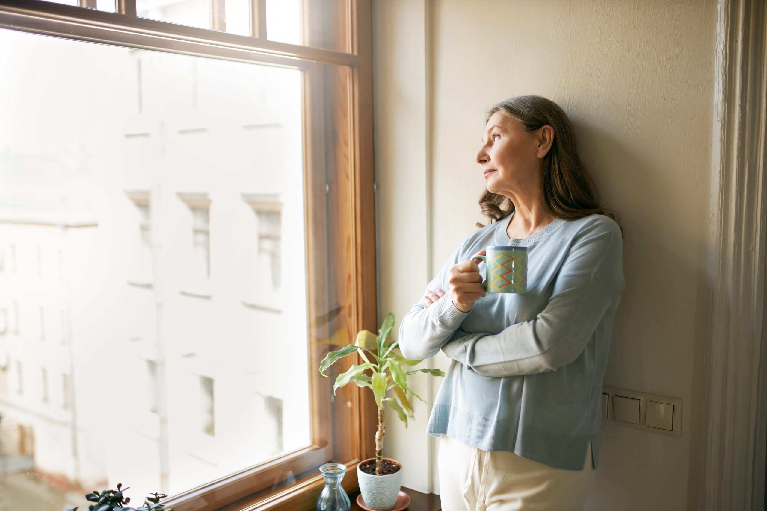 woman looking out window