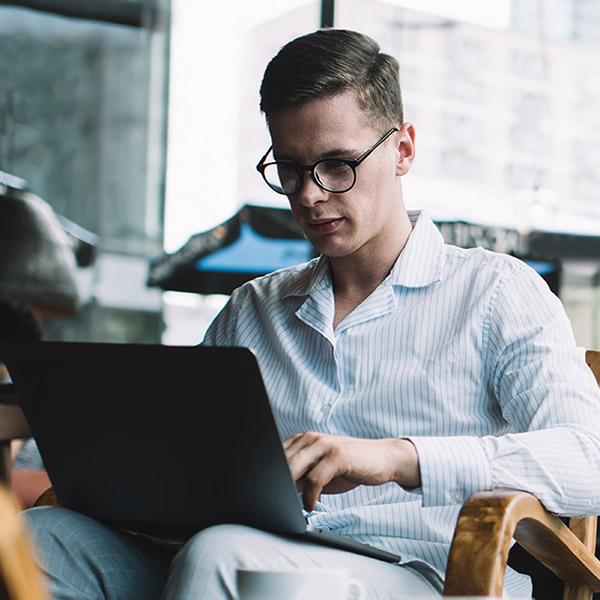 Man Typing on Laptop