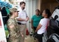 Guam residents and members of Task Force RISEUP, which is short for Roofing Installation Support Emergency Utilization Program, celebrate completion of the 100th temporary, emergency roof install during recovery efforts following Typhoon Mawar, June 27, 2023.