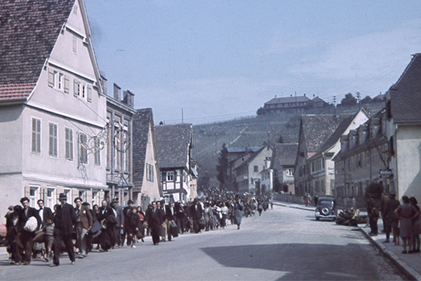 German police supervise the deportation of Sinti and Roma people, while onlookers watch from the other side of the road, Asperg, Germany, May 1940. Courtesy of Bundesarchiv, R 165 Bild-244-42/photographer: unknown