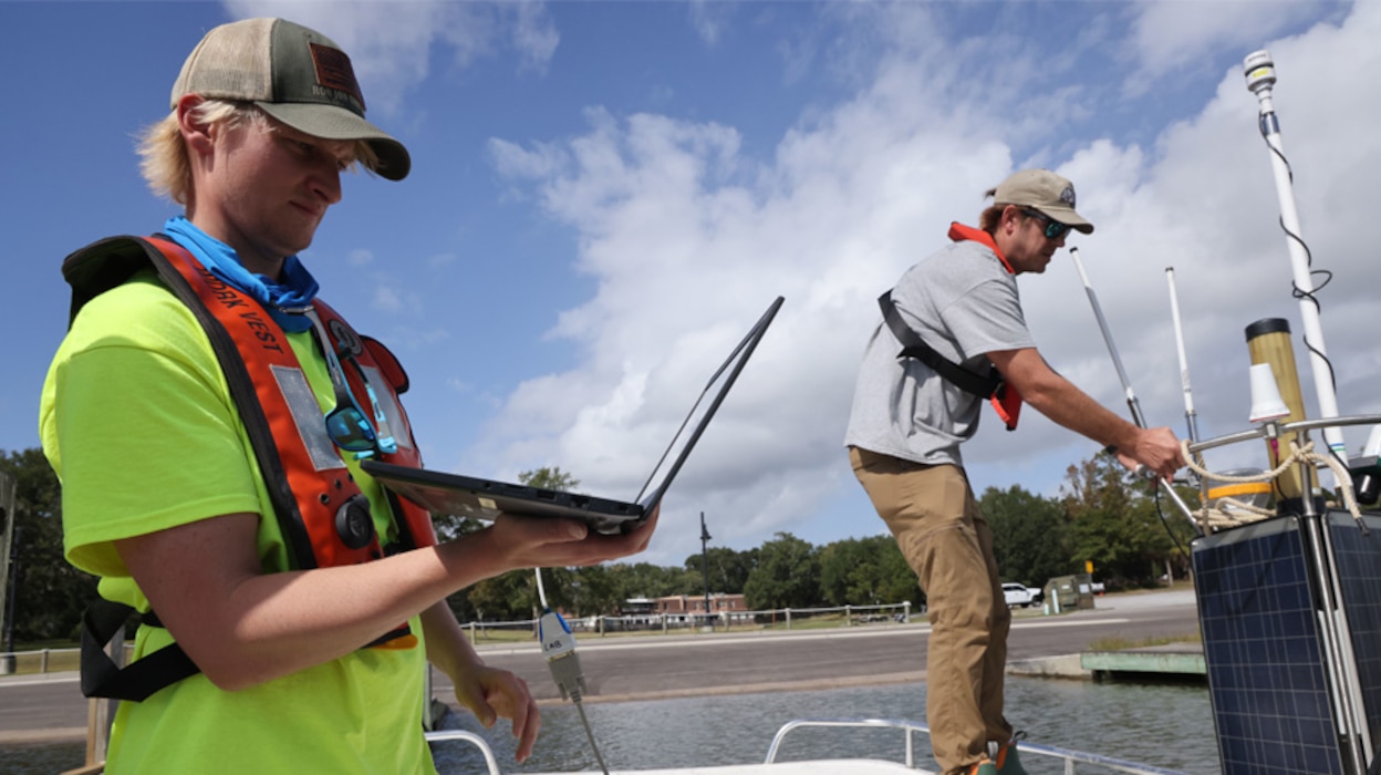 Chase Ferrell, left, a U.S. Army Corps of Engineers, Mobile District hydrologic technician, and Brett Hegler, a National Oceanic and Atmospheric Administration (NOAA) Field Engineering technician, calibrate a Real-Time Currents and Meteorological buoy (CURBY) in the Biloxi Bay near Ocean Springs, Mississippi, Oct. 25, 2023. The CURBY buoy was being launched to gather data for the USACE Mississippi Coastal Improvement Program and its coast-wide beach and dune ecosystem restoration project in Jackson County, Mississippi. (U.S. Army photo by Chuck Walker)