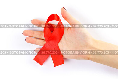 Hand holding red ribbon on a white background. Folded ribbon. Close up