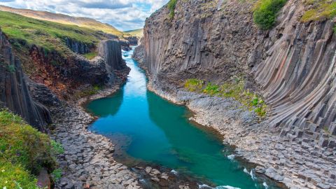 Jokla glacial river and basalt columns, volcanic rock formations at Studlagil / Stuolagil Canyon, Jokuldalur / Glacier Valley, Austurland, Iceland. (Photo by: Arterra/Sven-Erik Arndt/Universal Images Group via Getty Images)