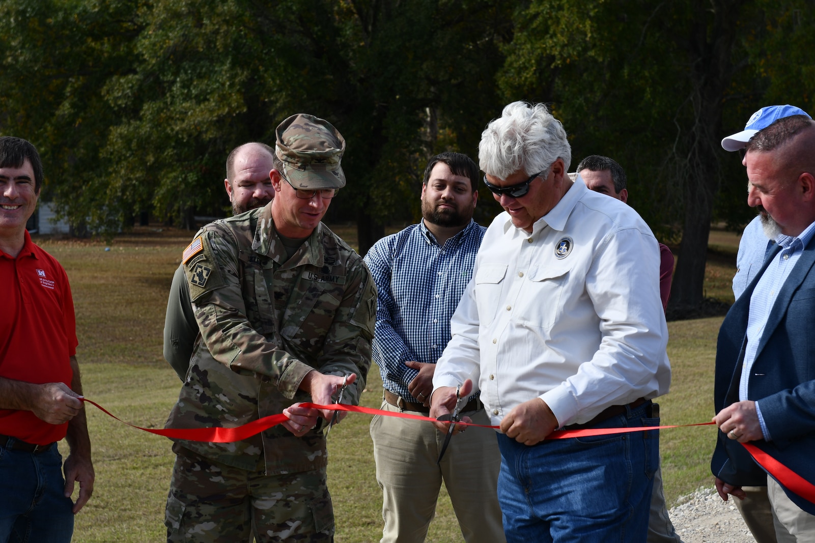 USACE Vicksburg District Commander Col. Christopher Klein cuts the ribbon to mark the completion of the Ouachita River Levees Crown Resurfacing Project Nov. 20, 2023. The project required 46,000 tons of limestone gravel, enough to fill a football field 15 feet deep.