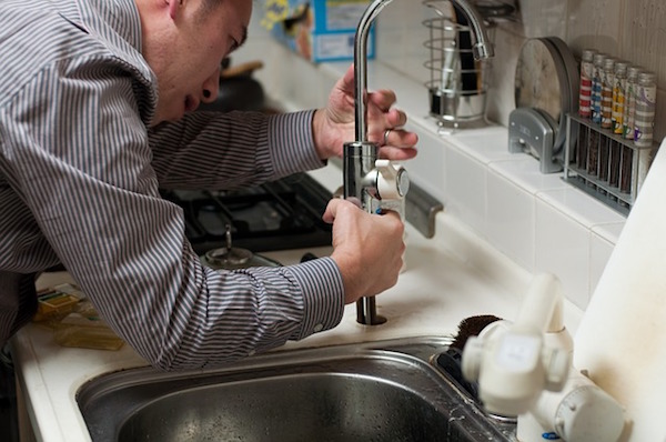 Plumber working on a faucet