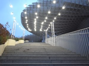 Trail of light leading to a huge wooden structure