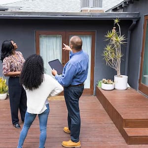 Inspector showing house exterior to a client