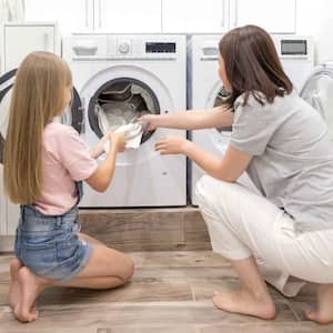 Daughter helping mom in the laundry room