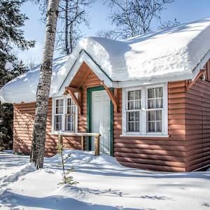 Cabin in the forest covered with snow