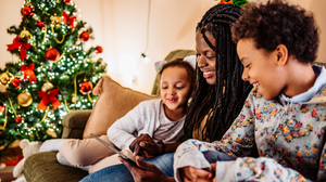 Kids watching cartoons with their mom on tablet on Boxing Day.