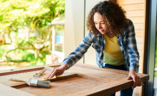 woman sanding a door