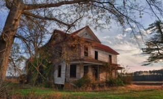 Haunted-looking Farmhouse at Sunset