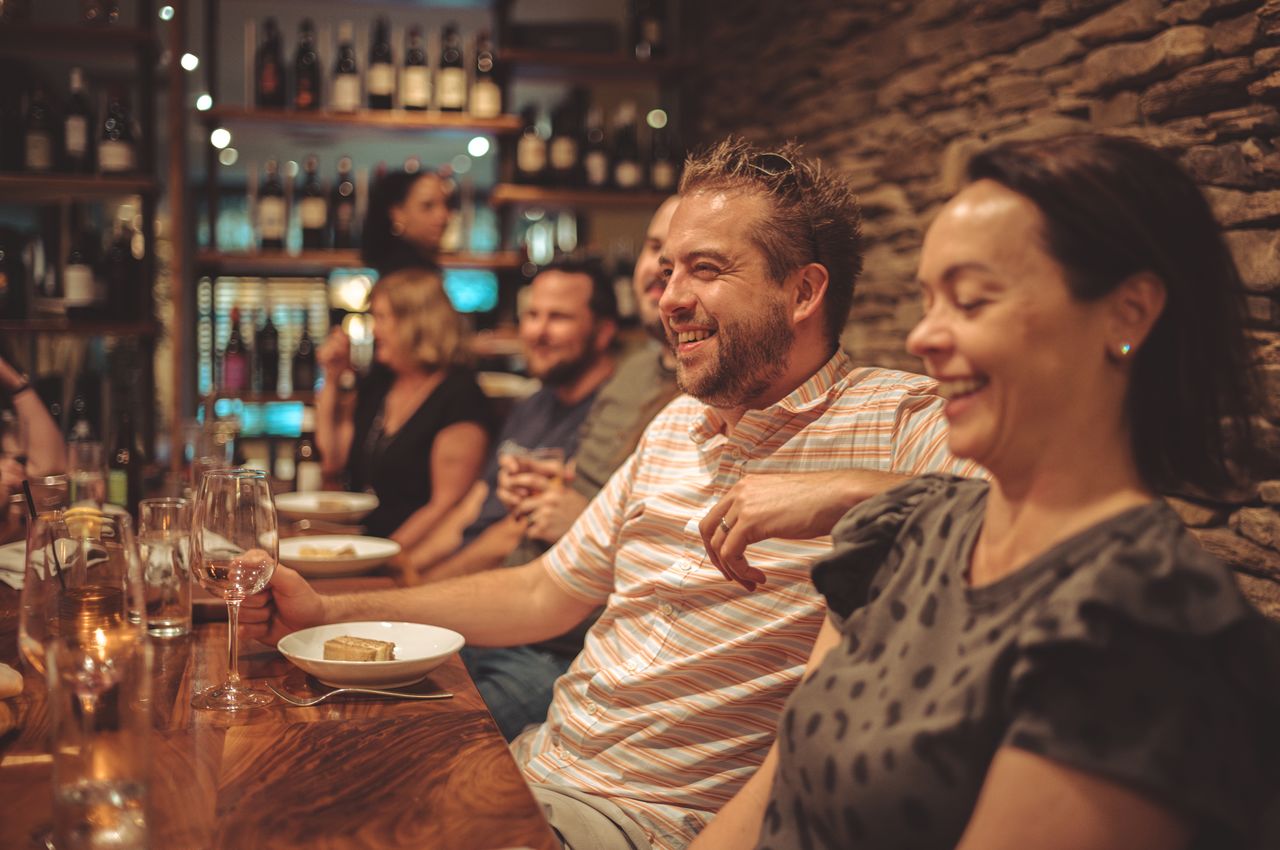 Dries sitting at a dinner table, laughing.