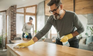 man cleaning dust from kitchen