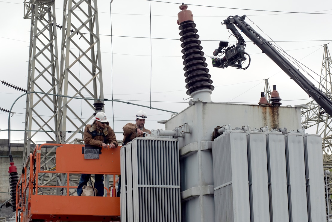 Senior Electrician Ron Gatlin (Right) and Electrician Kyle Mosakowski are captured on video Nov. 2, 2021 working in the Center Hill Dam Switchyard in Lancaster, Tennessee, for a U.S. Army Corps of Engineers National Inventory of Dams video production. The Nashville District operates and maintains the project on the Caney Fork River in Lancaster, Tennessee. (USACE Photo by Lee Roberts)