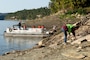 Hailey Heins, sophomore and Jr. ROTC cadet at Pulaski County High School, picks up trash on the shoreline of Lake Cumberland near Burnside, Kentucky, on National Public Lands Day Sept. 25, 2021. (USACE Photo by Lee Roberts)