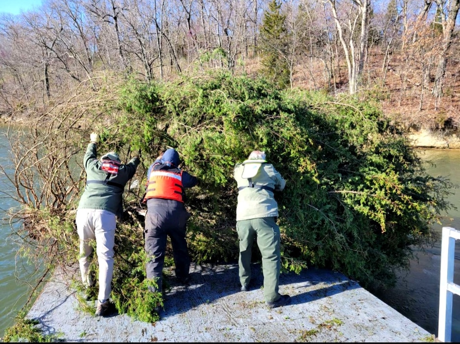 A group of 10 people amongst three agencies, USACE, Missouri Department of Conservation and Jackson County Parks and Rec are dropping brush piles into Blue Springs Lake for the first time in over 20 years. Together, these three agencies loaded and strategically placed about 80 brush piles, giving small fish a great new habitat to concentrate and hide from anglers. This both improves lake habitat and a fisherman’s record! Maps of the brush pile locations will be available in the next few weeks on our Blue Springs website and through MDC’s Mo Fishing App.