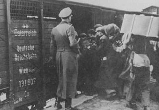 Jews are forced into boxcars destined for the Belzec killing center.