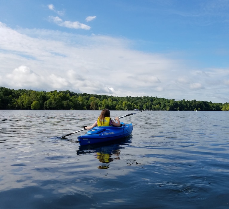 A girl kayaking on Rough River Lake in Falls of Rough, Kentucky.