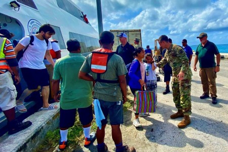 U.S. Army Garrison – Kwajalein Atoll Commander Col. Drew Morgan, center right, welcomes Roi-Namur evacuees to Kwajalein Island on Jan. 21. Roi-Namur is a four-hour boat trip from Kwajalein.