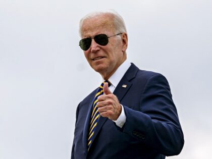 US President Joe Biden gives a thumbs up while boarding Air Force One at Joint Base Andrew