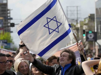 Presidential hopeful Javier Milei, of the Liberty Advances coalition, holds an Israeli fla