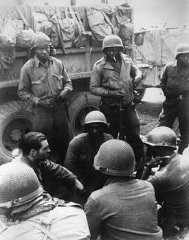 Members of the 12th Armored Division, which included African American platoons, await their orders. Germany, April 1945.