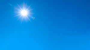 Image of bright Sun in blue sky.