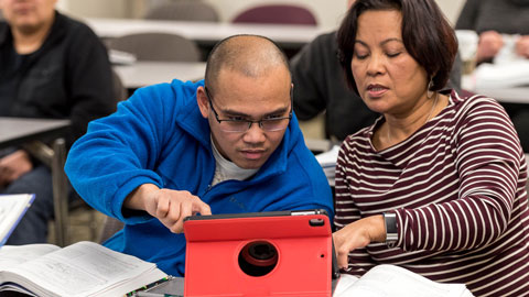 two students working on an ipad