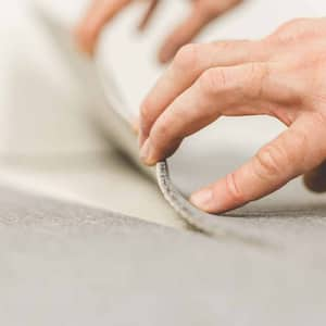 Worker removing old carpet