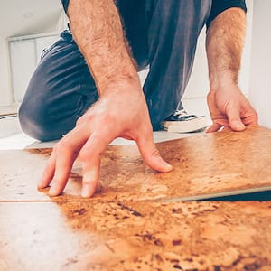 Professional installing cork floor by a floating method