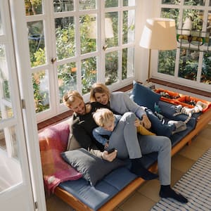 Family sitting on couch in sunroom